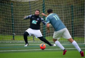 Goalkeeper defends against a player in a football match in Centre-Val de Loire, France.